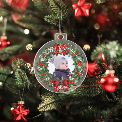 Custom photo Christmas ornament with festive wreath hanging on a tree