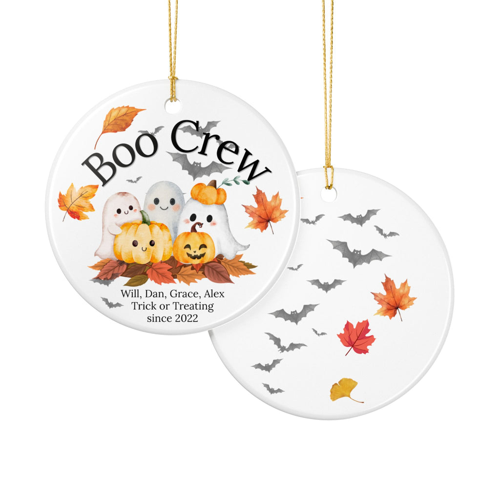 Two round white ceramic Halloween ornaments hanging from gold strings on a white background. The left ornament shows the front design with the text 'Boo Crew,' cartoon pumpkins, ghosts, autumn leaves, and personalized names printed near the bottom.