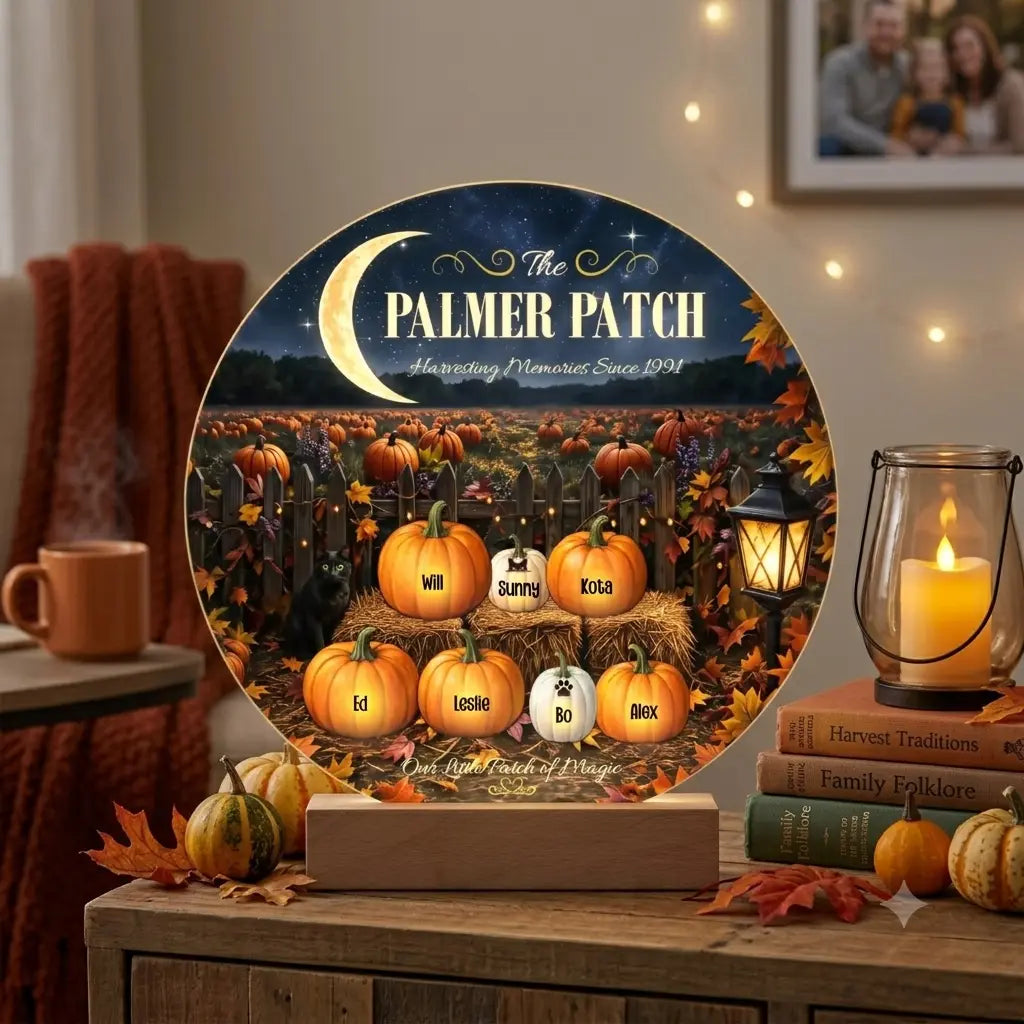 A personalized round decorative plaque on a wooden stand, displayed in a cozy autumn-themed room setting. The plaque features a night sky with a crescent moon, the text 'The PALMER PATCH Harvesting Memories Since 1994', and seven custom pumpkin names with small grave markers on a field of pumpkins.