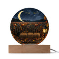 Round acrylic plaque featuring a pumpkin patch, crescent moon, and hay bales on a light wood base for fall decor.
